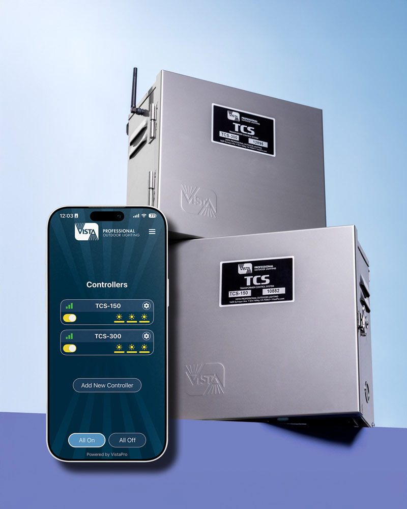 Two TCS Lighting Transformers stacked on top of each other, displayed alongside a mobile phone featuring the TCS controller app